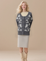 Women's embroidered cardigan sweater with front button placket and cable knit design.
